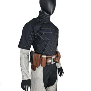 May include: A black and white jumpsuit with a high collar and short sleeves. The outfit features white stitching and a brown utility belt with pouches and a silver buckle. Black gloves complete the look.