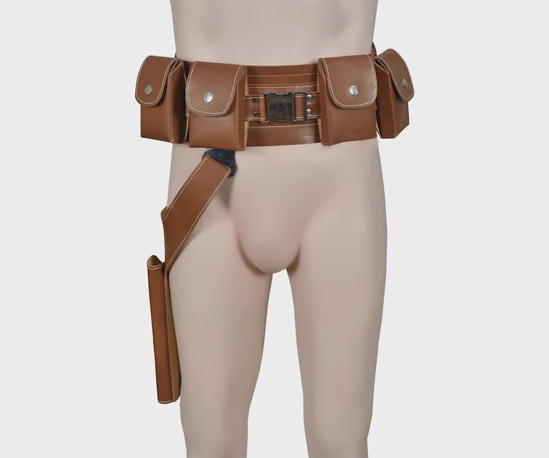 May include: A brown leather utility belt with multiple pouches and a holster. The belt has a rectangular buckle and is designed to be worn around the waist. The pouches have a flap closure with a silver button.