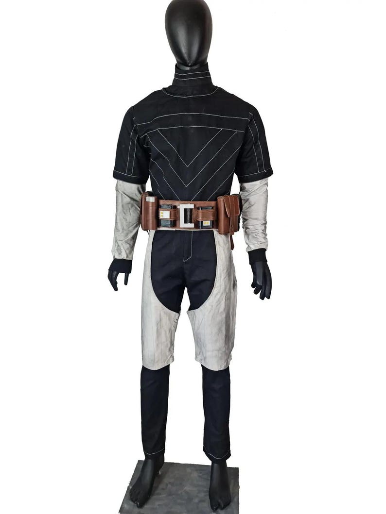 May include: A black and white cosplay costume on a mannequin. The outfit features a short-sleeved top with white stitching, matching trousers, and a brown belt with pouches. The sleeves and shorts have a grey accent.