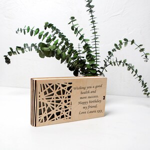 May include: A wooden box with a laser-cut design on the front. The box has a message engraved on the front that reads: "Wishing you a good health and more success. Happy birthday my friend. Love Laura xxx".