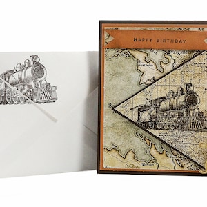 May include: A birthday card with a vintage map design and a steam train illustration. The card features a banner that reads "HAPPY BIRTHDAY". An envelope with a matching train illustration is included.