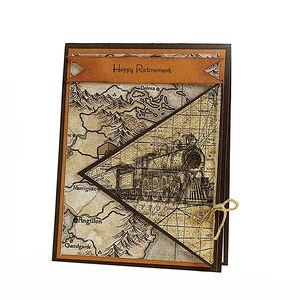 May include: A handmade retirement card with a vintage map and train design. The card features a banner that reads "Happy Retirement." The card is tied with a twine bow. The card has a brown and tan color scheme.