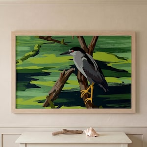May include: A framed art print featuring a stylized illustration of a bird perched on a branch. The bird has gray and black feathers, yellow legs, and a red eye. The background is a green and dark green abstract landscape.