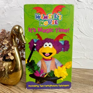 May include: A vintage VHS tape for "Wimzie's House: It's Magic Time!" features a green background with the show's logo and a cartoon character. The box includes the text "Including Two Fantabulous Episodes!" and a cartoon character with a magic wand.
