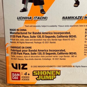 May include: A product box featuring the text "UCHIHA ITACHI" and "NAMIKAZE M". The box includes the "SHONEN JUMP" logo and the text "MADE IN CHINA". The box is orange and white.