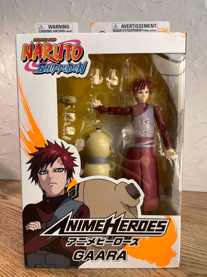 May include: A boxed Anime Heroes Gaara action figure from Naruto Shippuden. The figure is in a clear plastic display case with extra hands and a gourd accessory. The box features the Naruto Shippuden logo and the Anime Heroes logo.