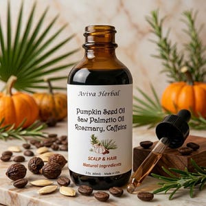 May include: An amber glass bottle of Aviva Herbal scalp and hair oil with a black dropper. The label lists Pumpkin Seed Oil, Saw Palmetto Oil, Rosemary, and Caffeine. It states 2 oz. (60ml) and Made in USA. The bottle has a black screw cap.