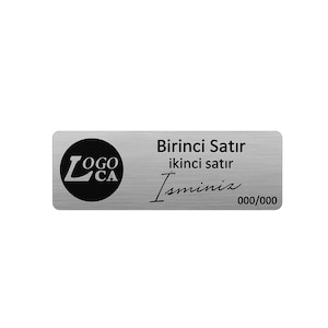 May include: A rectangular silver-coloured metal name tag with a brushed finish. On the left, a black circle contains the text LOGO CA. To the right, the text reads Birinci Satır, ikinci satır, Isminiz, and 000/000 in black, sans-serif and script fonts.
