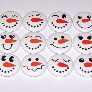 May include: Twelve white round buttons with different snowman faces. Each button has a black outline and features a red nose, black eyes, and a variety of facial expressions.