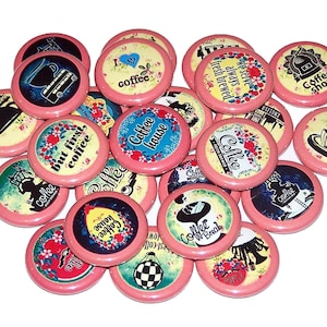 May include: A collection of 18 pink and white coffee themed buttons with various designs and sayings. The buttons feature images of coffee cups, coffee beans, coffee pots, and text such as "Coffee House", "But First, Coffee", and "Coffee Shop".