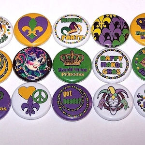 May include: Twelve Mardi Gras themed buttons with various designs, including crowns, beads, jester hats, and fleur-de-lis. The buttons are yellow, green, purple, and white.