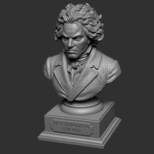 May include: A gray bust of Beethoven, featuring detailed facial features and curly hair. The sculpture is mounted on a rectangular base with the name "BEETHOVEN" and the years "1770-1827" inscribed on a plaque.