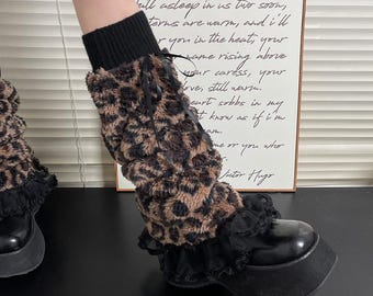 May include: Black platform shoes with a thick sole are paired with leopard print leg warmers. The leg warmers have a black knit top and a black lace trim at the bottom. A framed quote is in the background.