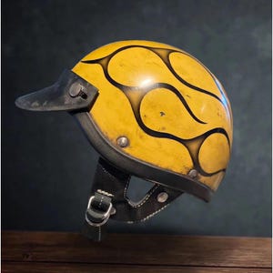 May include: Yellow motorcycle helmet with black flame design. The helmet has a black visor and a black leather chin strap with a metal buckle. The helmet is a vintage style.