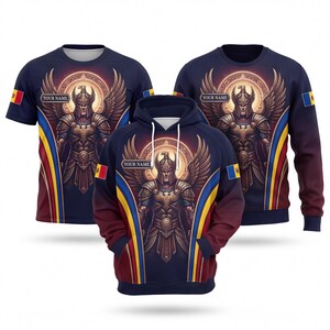 May include: A navy blue t-shirt, a long-sleeve sweatshirt, and a hooded sweatshirt featuring a winged warrior graphic with a glowing halo. Each garment displays the Moldovan flag on the sleeve and a rectangular box with the text YOUR NAME.