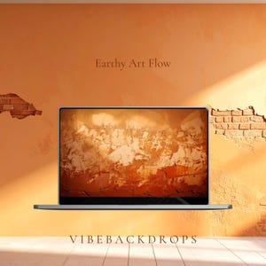 May include: A silver laptop displays an abstract, textured background in shades of brown and orange. The laptop is set against an orange wall with exposed brick and the text "Earthy Art Flow" and "VIBEBACKDROPS".