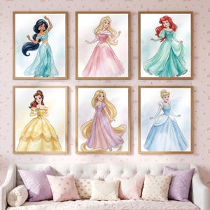 May include: A set of six framed wall art prints featuring watercolor-style illustrations of female characters in gowns. The characters include figures with long dark hair in blue, blonde in pink, red in green, brown in yellow, blonde in purple, and blonde in blue.