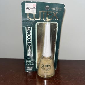 May include: A bottle of Cutex Perfect Color for Nails nail polish in a gold colour. The packaging includes the words "Perfect Color" and "White Lightning Special Effect". The bottle is 11 ml.