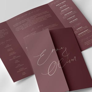 Könnte beinhalten: Burgunderfarbenes Hochzeits-Programm im Dreifach-Falz mit elegantem Schriftzug. Das Programm zeigt die Namen "Emma & Oliver" auf der Vorderseite. Details zur Hochzeitsgesellschaft, zum Ablauf und zu den Gästen.