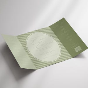 May include: A tri-fold wedding invitation in shades of green and white. The invitation features the names "Emma and Oliver" in elegant script within an oval frame. The date and time are also displayed, along with a QR code.