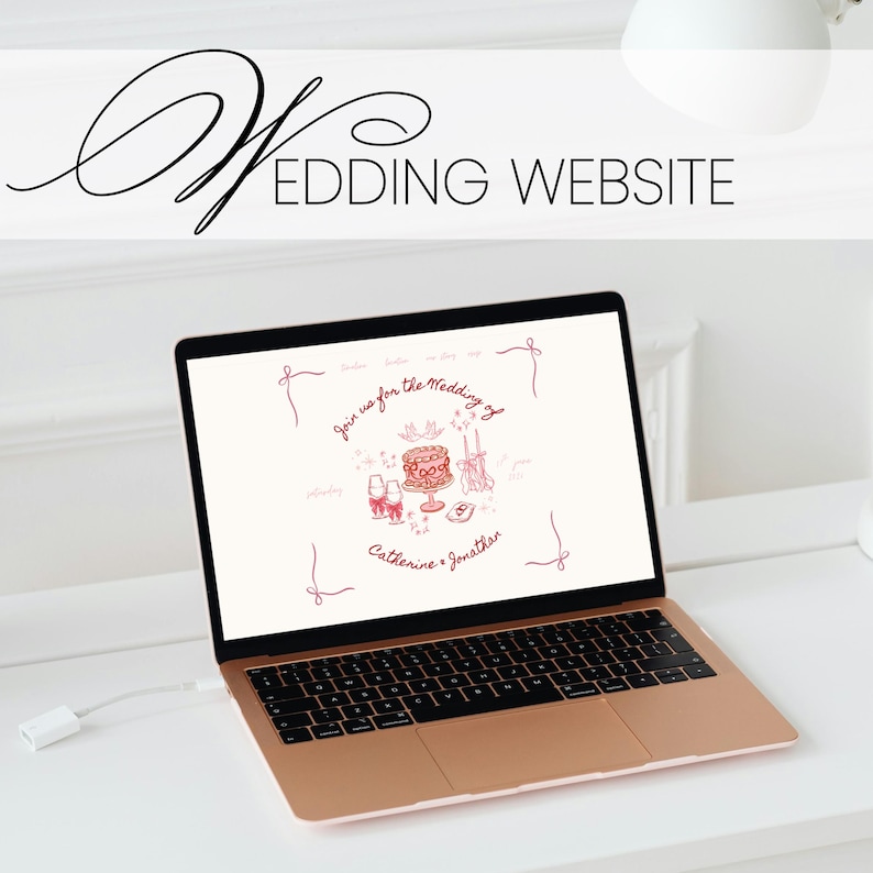 May include: A rose gold laptop displays a wedding website with the text "Wedding Website." The screen shows a pink illustration of a cake, champagne glasses, and the names "Catherine & Jonathan."