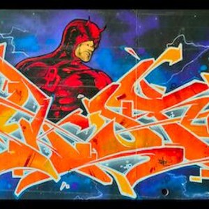 May include: Graffiti art featuring the superhero Daredevil in a red suit, set against a backdrop of orange and yellow graffiti. The background has blue and purple hues with lightning bolts.
