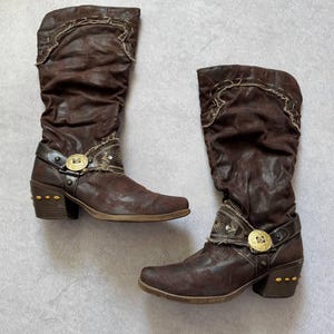 May include: A set of three ceramic mugs with a speckled, matte finish. The mugs are in shades of cream, light gray, and dark gray. Each mug has a simple, minimalist design and a rounded handle.