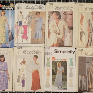 May include: A collection of vintage Simplicity sewing pattern envelopes. The patterns feature illustrations of dresses, suits, and other garments. The envelopes are in various colors and styles, showcasing fashion trends.
