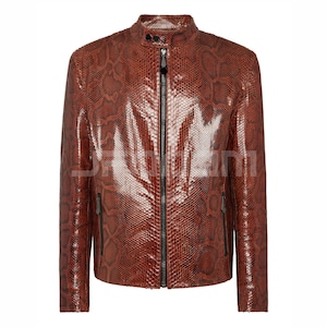 May include: A brown leather jacket with a snakeskin pattern. The jacket features a stand-up collar, a full-length zip, and two zipped pockets. The jacket is a medium brown colour.