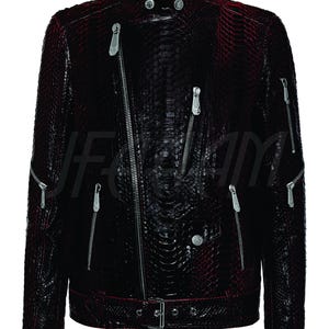 May include: A dark burgundy leather jacket with a snakeskin texture. The jacket features a stand-up collar, multiple silver zips, and a belt at the waist. The jacket has a biker style.