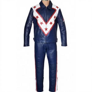 May include: A two-piece blue leather outfit with white and red star accents. The jacket has a white chevron design with red stars and a white collar. The pants have a white and red stripe down the side. The outfit is a full-body garment.