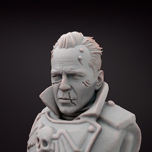 May include: A grey bust of a man with a serious expression, short hair, and facial scars. He is wearing a military-style coat with a skull motif. The sculpture is set against a dark background, highlighting the details.