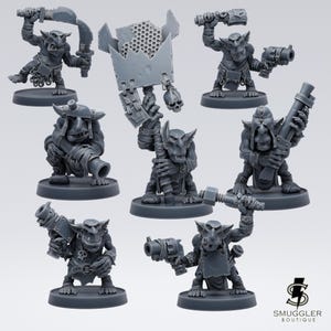 May include: A collection of gray miniature fantasy figures, each depicting a goblin-like creature in various action poses. Some figures wield weapons like swords, cannons, and blasters. The figures are on round bases, suitable for tabletop gaming or collecting.