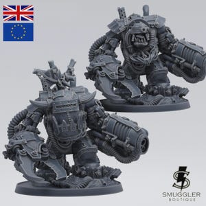 May include: Two gray miniature figurines of a robotic warrior with large claw-like hands and a cannon arm. The figures are on a circular base, with intricate mechanical details and tubing. The Smuggler Boutique logo is in the bottom right corner.