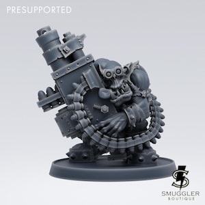 May include: A gray, presupported miniature figure of a fantasy orc holding a large weapon. The orc has goggles and a menacing expression. The weapon has a large barrel and a belt of ammunition. The figure is on a round base with the Smuggler Boutique logo.