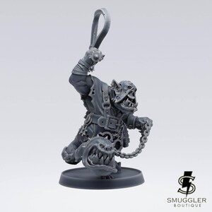 May include: A grey miniature orc figure, wielding a whip and a chained creature with sharp teeth. The orc is dressed in torn clothing and a belt. The figure is mounted on a circular base.