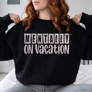 Sage green script font saying on vacation for beach vibe shirts.