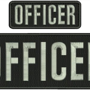 May include: Two black embroidered patches. The word "OFFICER" is displayed in white, block letters. One patch is rectangular, the other is smaller. The patches have a textured appearance.