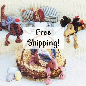 May include: A collection of handmade stuffed animal toys, including a dog, cat, reindeer, and bunny. The toys are made from fabric and have a variety of colors and patterns. The text "Free Shipping!" is displayed on a white background.