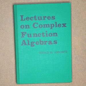 May include: A hardback book featuring a bright green cover with dark grey text. The title is printed as Lectures on Complex Function Algebras, with the author named as Gerald M. Leibowitz. The book is rectangular in shape with a vertical spine on the left.