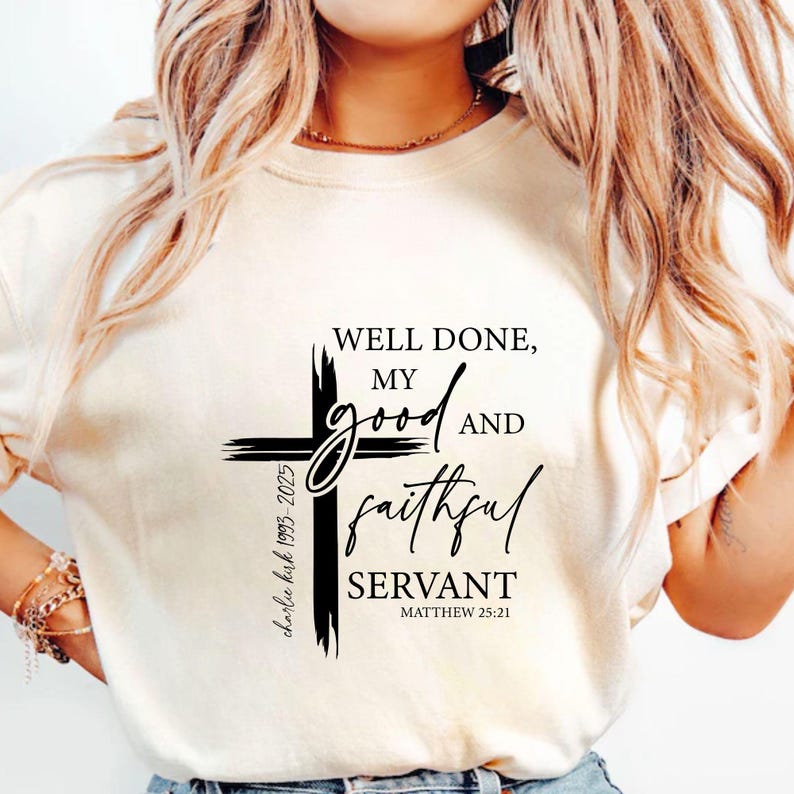 May include: A cream-coloured t-shirt with a black cross design. The text reads "WELL DONE, MY GOOD AND FAITHFUL SERVANT" and Matthew 25:21. The shirt also includes the text "charlie kirk 1993-2025".