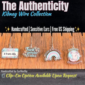 May include: Four pairs of acrylic dangle earrings featuring various designs: a name tag reading 'HELLO I'M A Trans Ally', text saying 'Fuck gender roles' with flowers, a rainbow with 'TRANS IS BEAUTIFUL', and an axolotl with 'I SUPPORT TRANSOLOTLS'.