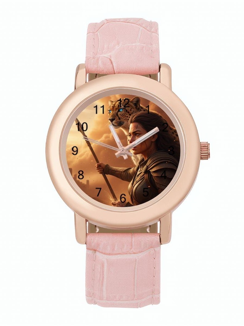 May include: A rose gold wristwatch with a pale pink leather strap. The watch face depicts a woman with a spear and a leopard against a sunset. The watch has a round face with black numerals. The strap is approximately 20 cm long.