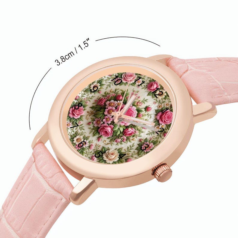 May include: A rose gold watch with a floral face featuring pink and white roses. The watch has a light pink leather band. The watch face is 1.5 inches (3.8 cm) in diameter.