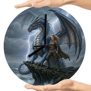 May include: Round wall clock featuring a fantasy scene with a blue dragon, a warrior, and lightning. The clock hands are black. The dragon has large wings and is standing on a cliff. The warrior is wearing brown clothing and a cape.