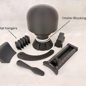 May include: A collection of black hat-making tools, including a hat form, hat hangers, a blocking cord, and other shaping tools. The tools are arranged on a light background, showcasing the essential components for millinery projects.