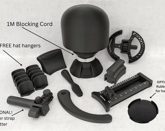 May include: A black hat blocking set including a dome-shaped head form, a 1M blocking cord, 10 hat hangers, a leather strap cutter, a measuring tool, and a circular rubber pad. The components are matte black plastic with white text labels.