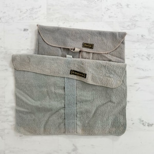 May include: Two gray felt storage bags with black labels. The top bag has the label "STEAK SET" and the bottom bag has the label "ICE CREAM SPOONS".