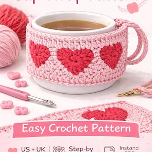 May include: A white mug with a pink crocheted heart-shaped cup wrap. The wrap features three red hearts. The image also includes pink yarn, crochet hooks, and the text "Heart Granny Square Cup Wrap Pattern" and "Easy Crochet Pattern".