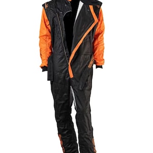 May include: Black and orange racing suit with a zip-up front. The suit features orange accents on the shoulders, sleeves, and sides, with the word "20M" printed in orange on the legs. The collar is black with an orange trim.